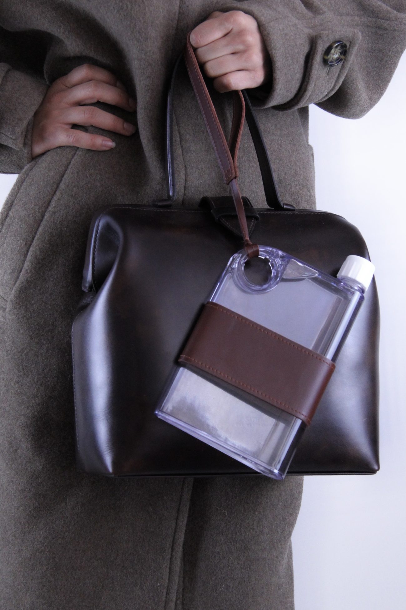 A handcrafted dark leather Safiera bag carried in the arm