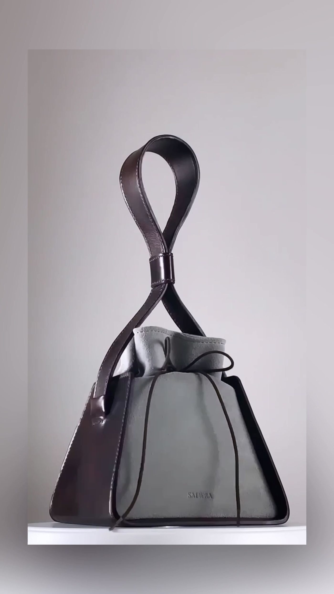 The Box, an evening bag with a sculpted looped handle